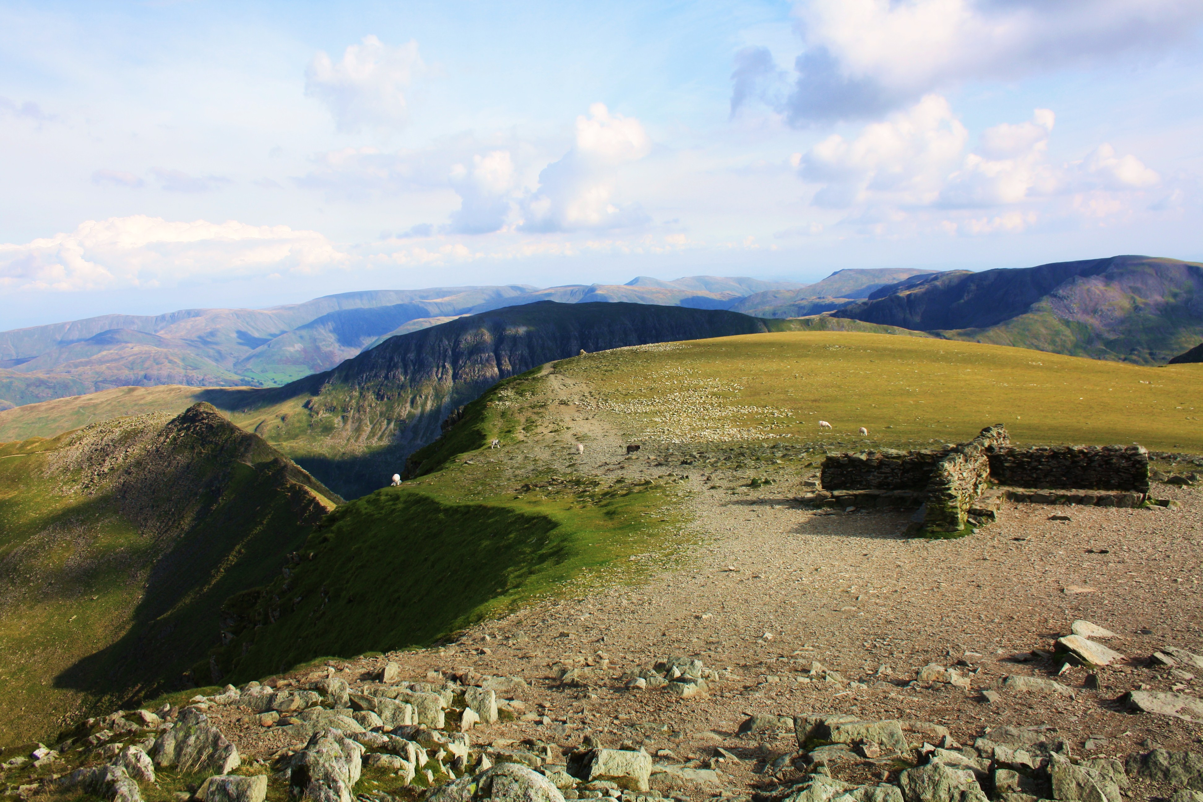 Helvellyn Summit Shelter with Striding Edge to the centre-left