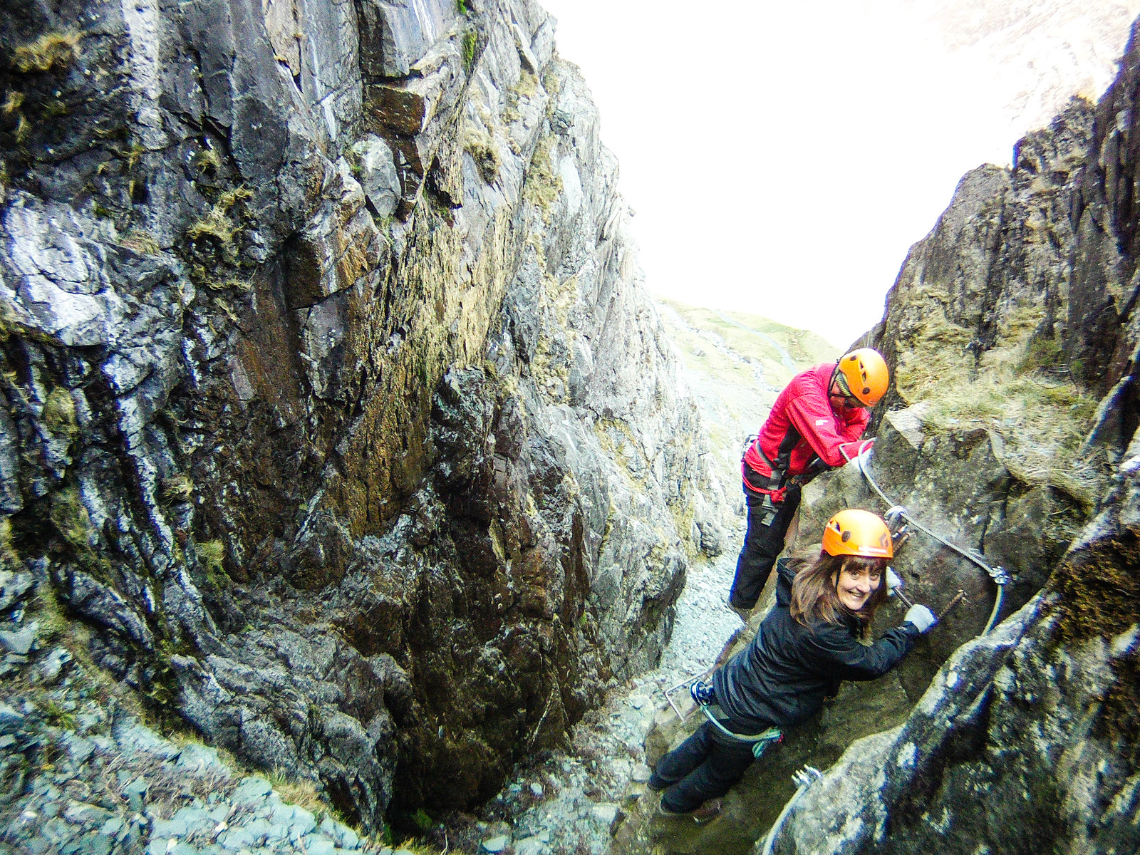 Navigating ladders overhanging a steep gully