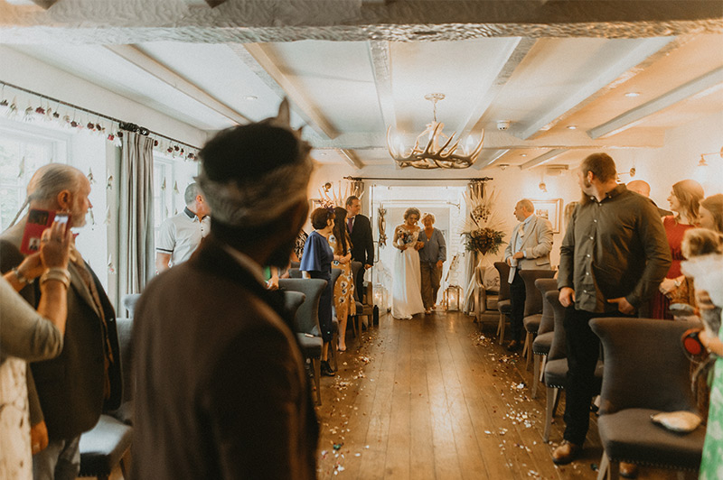 Bride entering the room of wedding guests