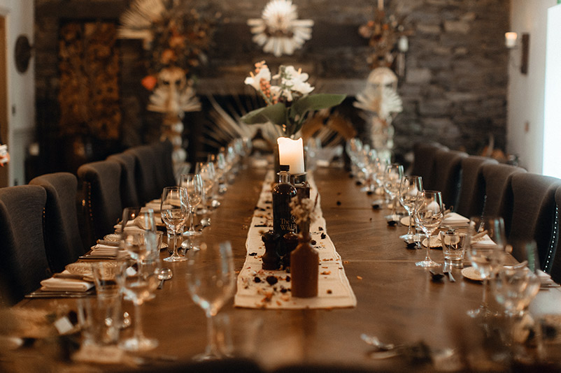 A long table decorated and set ready for a wedding breakfast