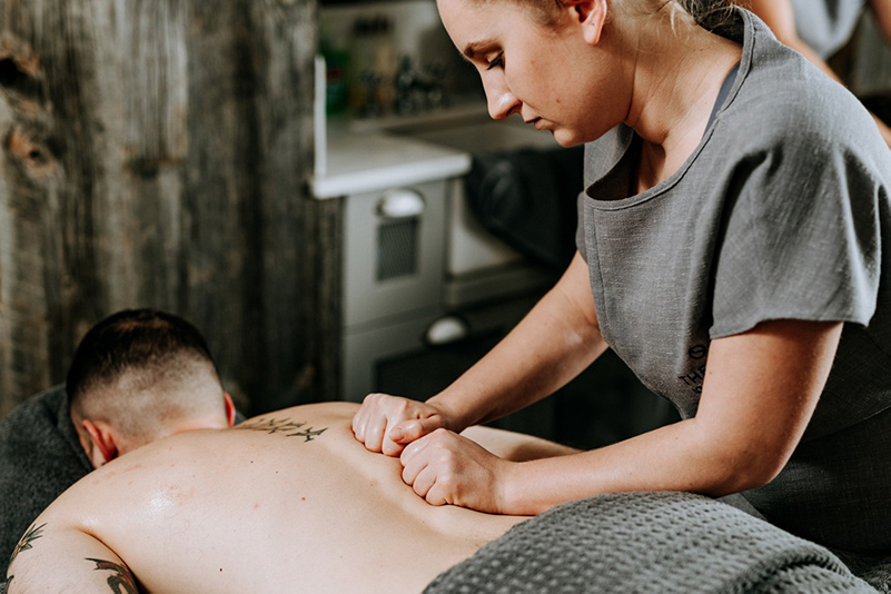 Spa therapist providing a back massage