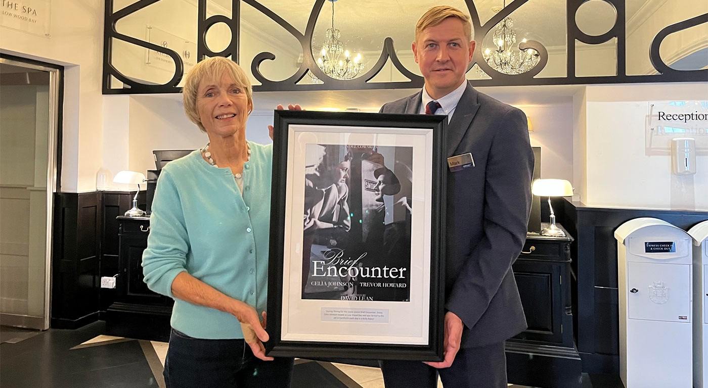 Lucy Fleming and Mark Needham with a framed version of the brief encounter film poster