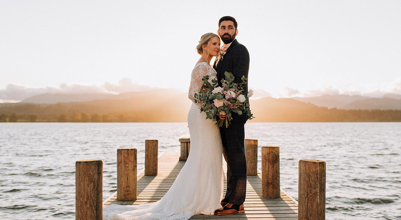 Newly wed couple stood on Low Wood Bays Jetty