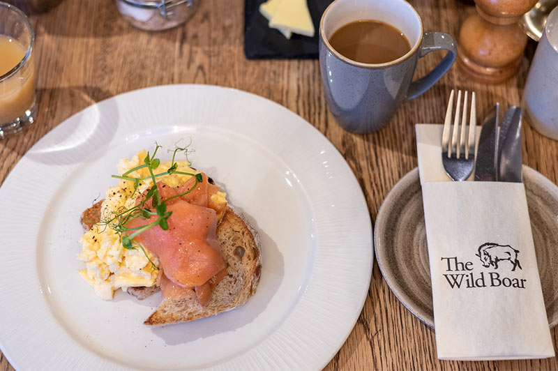 Breakfast offering of Treacle cured salmon with wholegrain rye bread and scrambled eggs